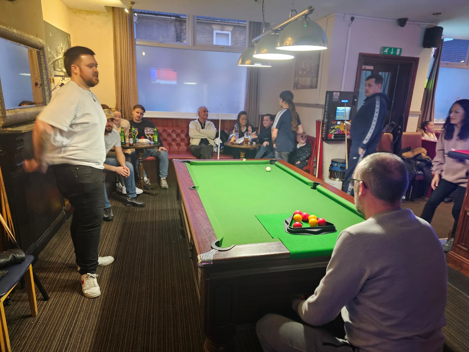 Crowd watching pool tournament action at The Weston Arms