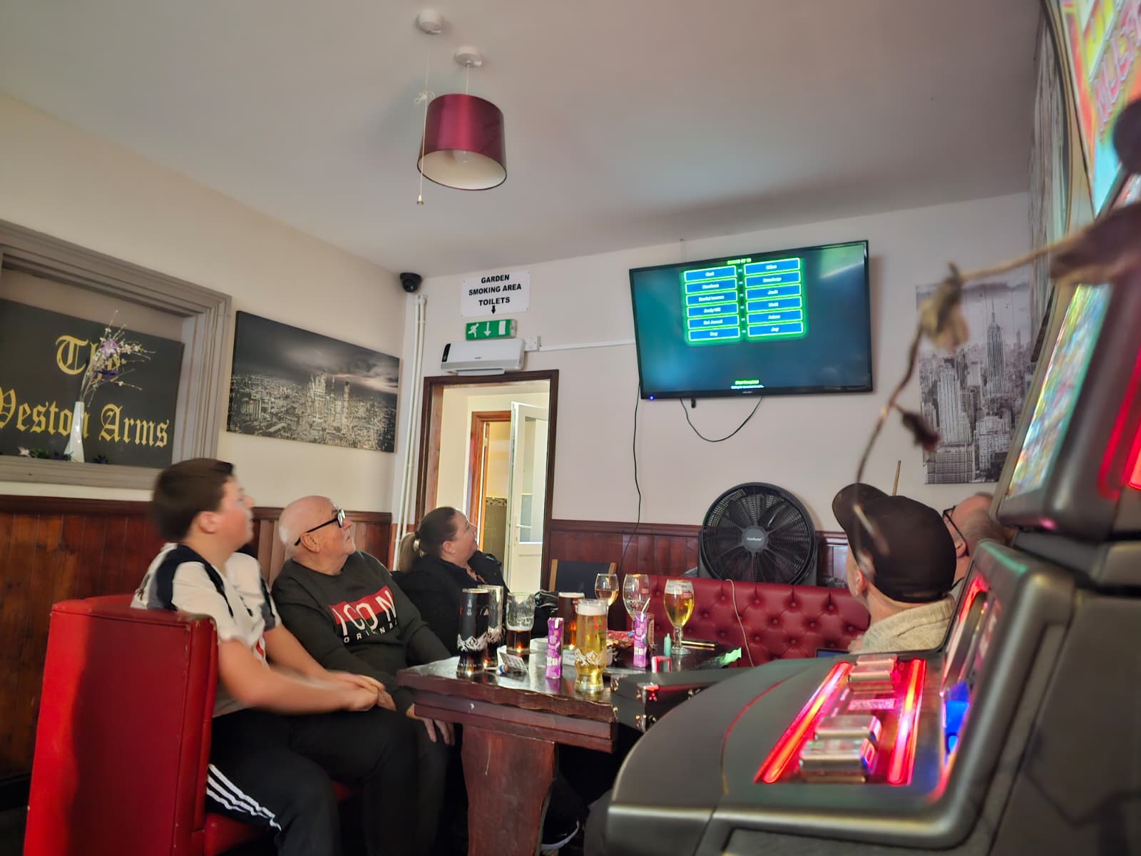 Pub regulars watching the tournament bracket on TV at The Weston Arms